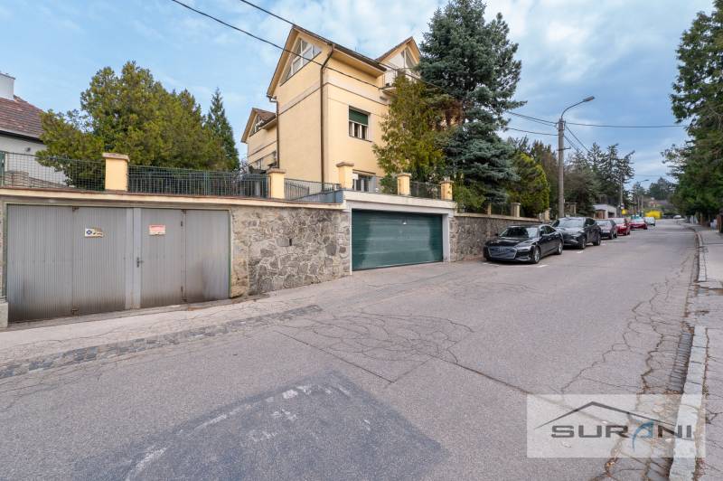 Krčméryho Street in Bratislava - Staré Mesto with a garage entrance and parked cars.