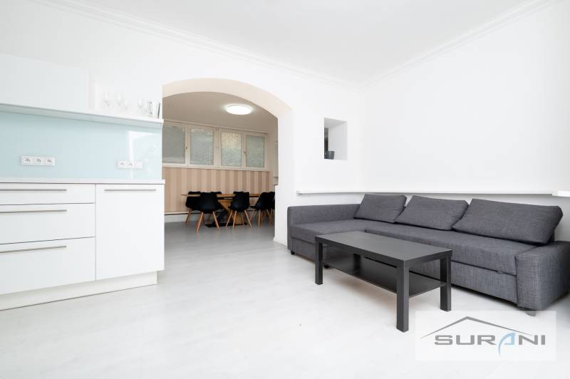 Living room of a 4-room apartment with a kitchenette and a sofa set.