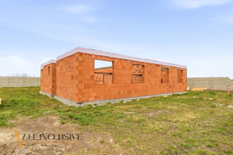 A family house under construction made of bricks with a plot in Veľké Dvorníky.