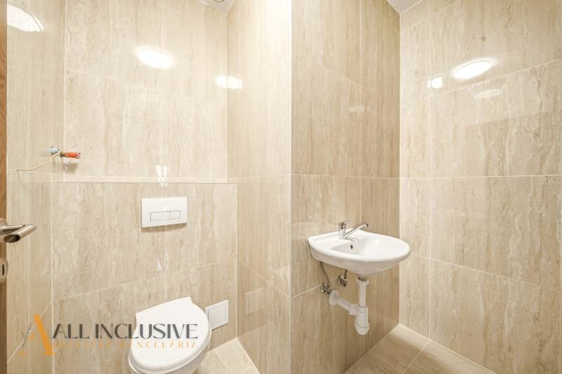 A bathroom in a family house with a white sink and toilet.