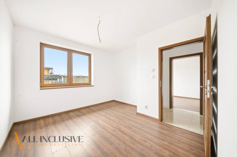 Interior with wood-patterned flooring, large window, and doors in a family house.