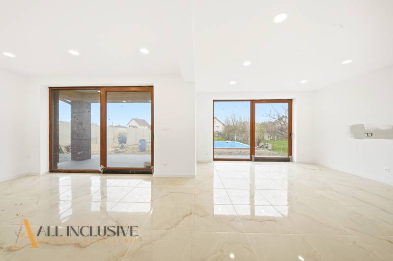 Living room in a family house with large glass doors and a view of the yard.