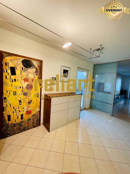 Interior of a family house with a tiled surface and a painting on the wall.