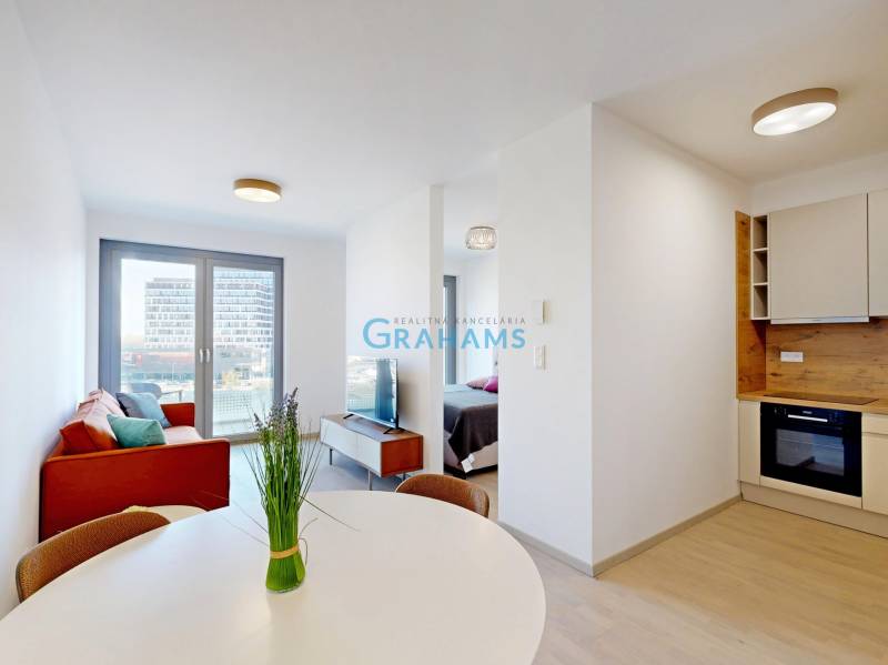 2-room apartment with wood-patterned flooring, dining table, and sofa.