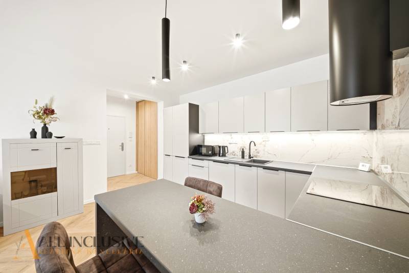 A kitchen in a 4-room apartment with subtle wall decorations and soft colors.