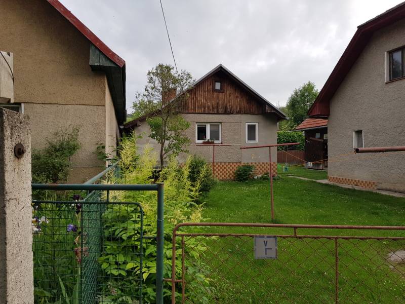 A family house in Blatnica, Blatnica, with a front garden and neighboring buildings.