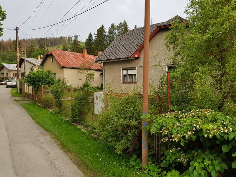 A family house on Blatnica Street in Blatnica, surrounded by greenery and a fence.