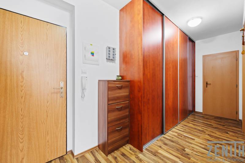 Interior of a 2-room apartment with a wood-decor floor and a built-in wardrobe.