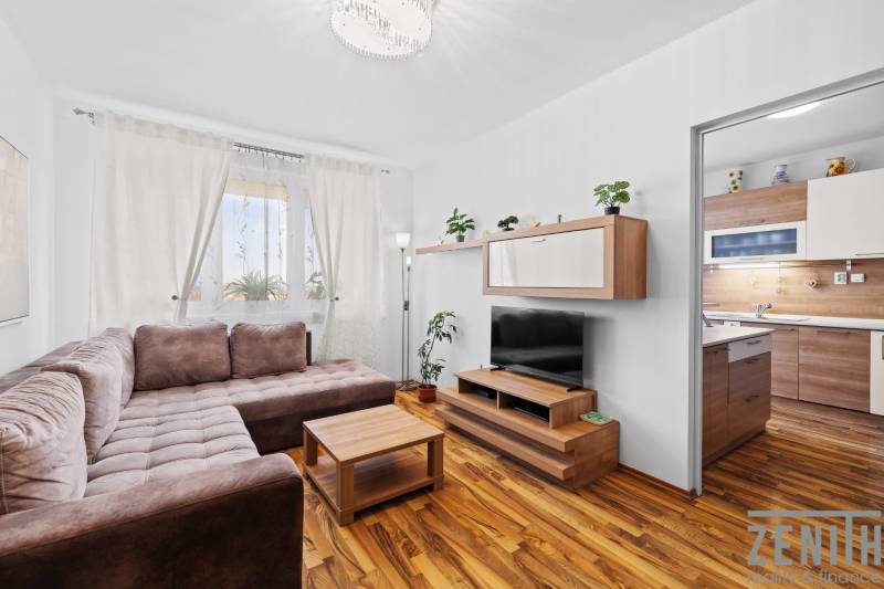 Living room in a two-room apartment with a sofa set and a wooden decor floor.
