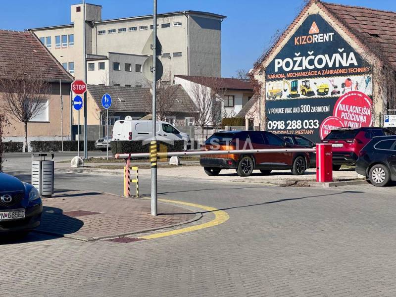A street in the city with cars, a bike lane, and a Tool Rental building, 1-bedroom apartment not mentioned.