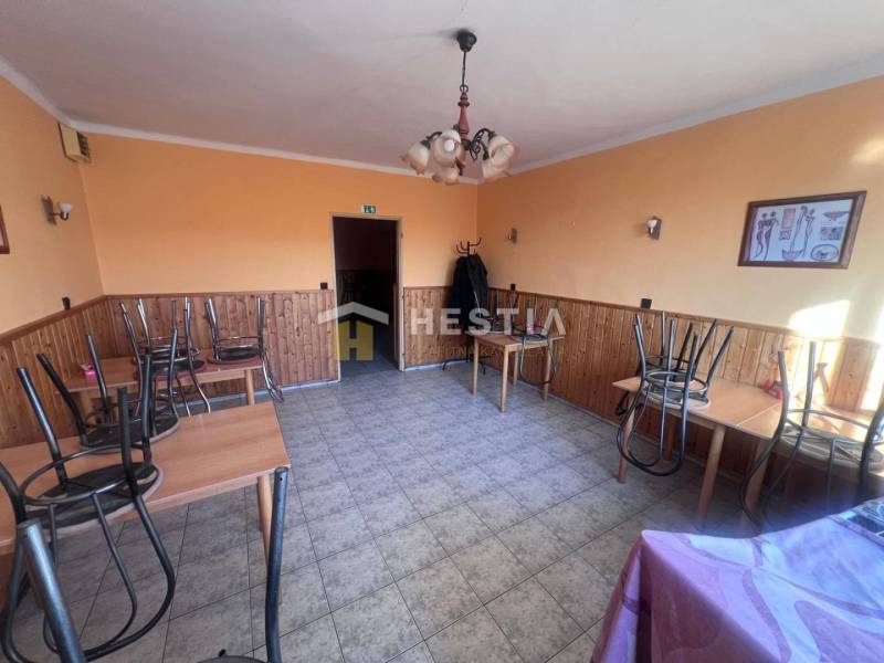 Orange-themed gastro spaces with tiled floors, tables with chairs turned upside down.