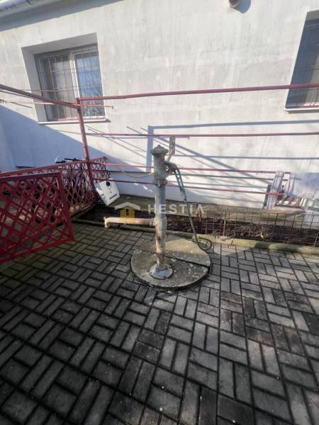 Water pump on concrete paving near the building in the Gastro premises in Senica.