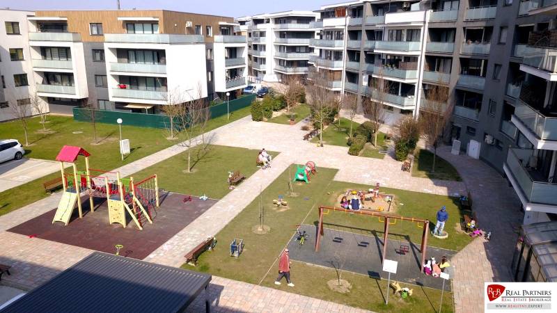 Apartment buildings with a children's playground on Orechova Street in Dunajská Lužná.