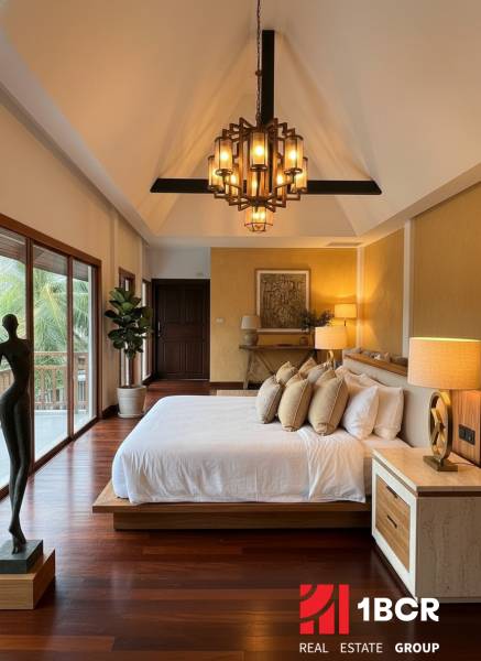Luxury bedroom in a villa with wood-patterned flooring and large windows.