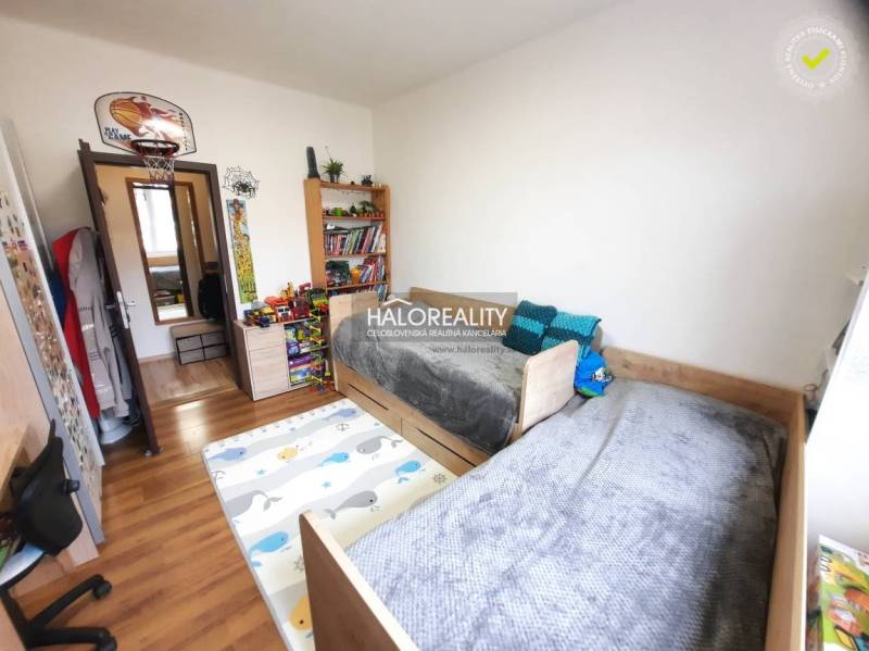 Children's room with wood-decor flooring in a 3-room apartment.