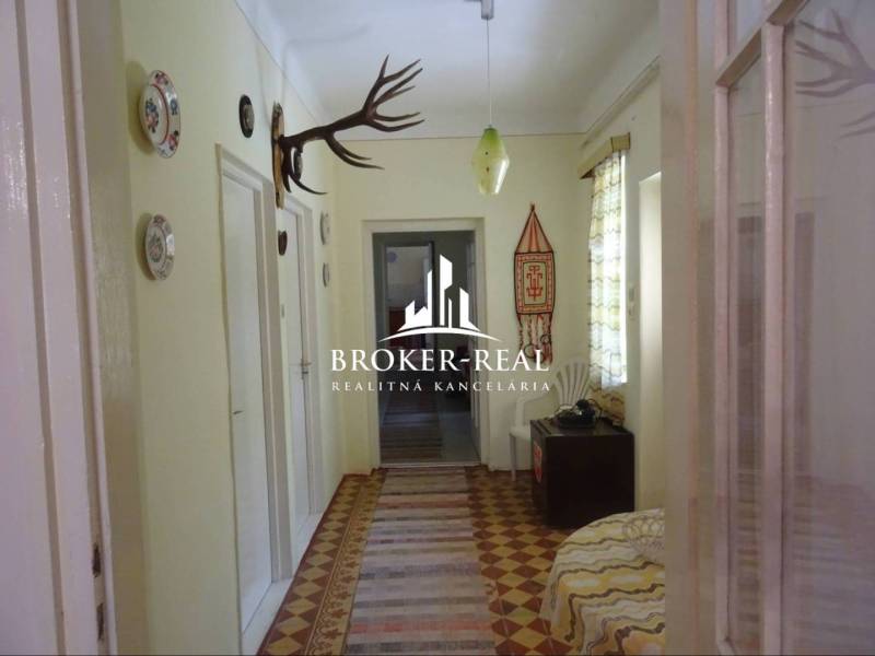 A hallway in a family house with hunting trophies and traditional decorations.