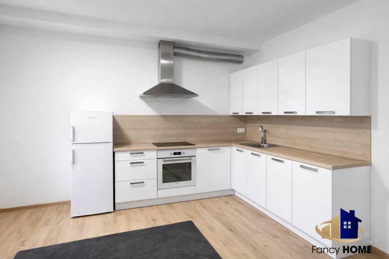 White kitchen, light decor, appliances and wooden decor flooring in a 2-room apartment.
