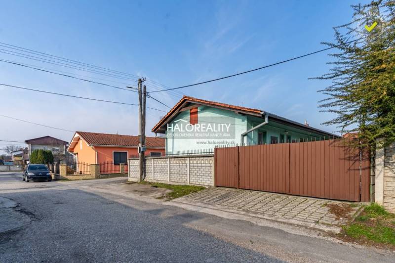 Street with family houses and a car in Veľký Meder, Hotels and guesthouses in the vicinity.
