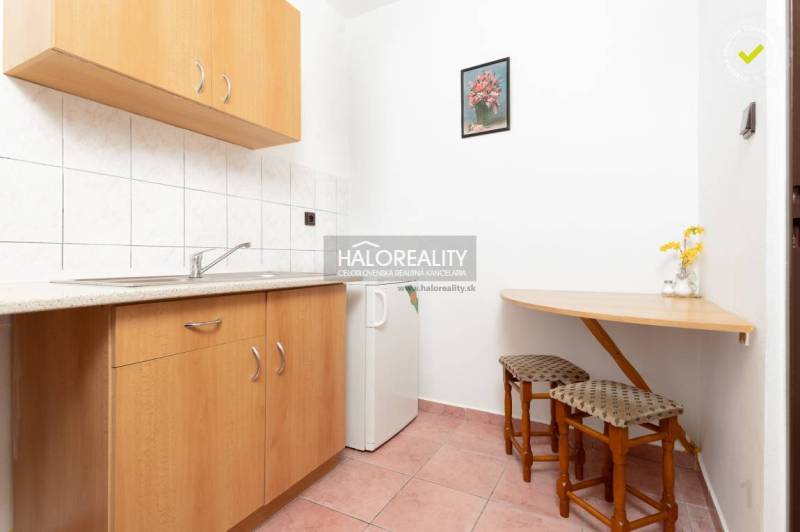 Kitchen corner in hotels and guesthouses with wooden decor and a small table.