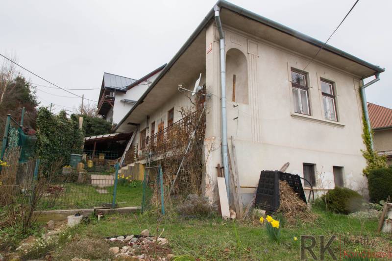 A family house in Kostoľany nad Hornádom with a front garden and wooden elements.