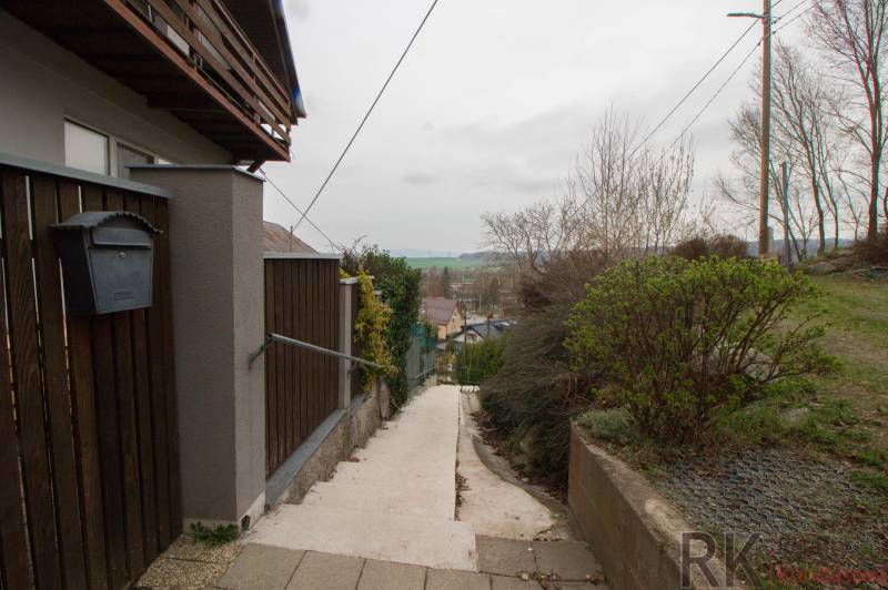 The access path to the family house in Kostoľany nad Hornádom, enclosed by a wooden fence.