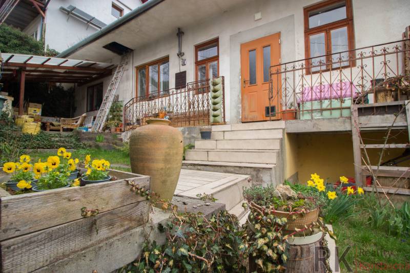 A family house in Kostoľany nad Hornádom with flowers, a terrace, and stairs to the garden.