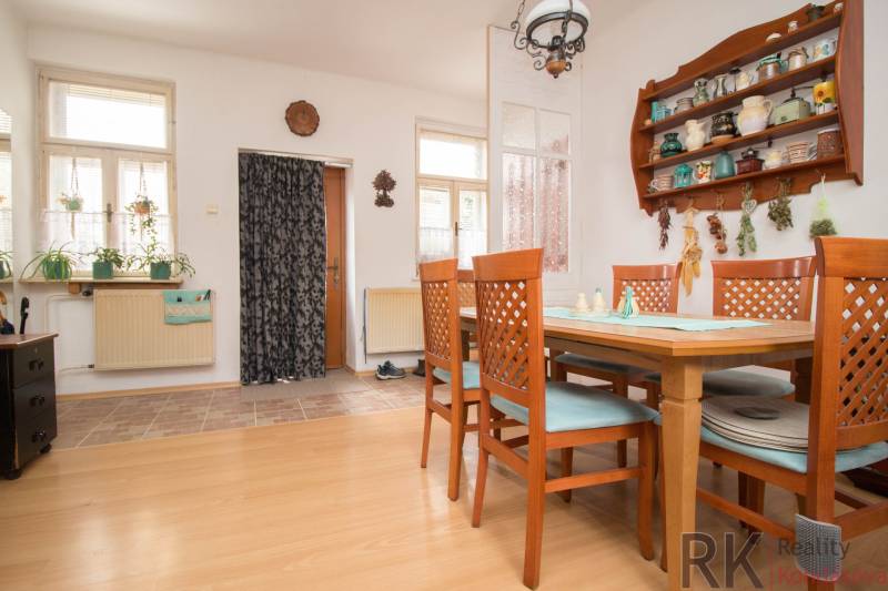Dining room in a family house with a wooden decor floor and wooden furniture.