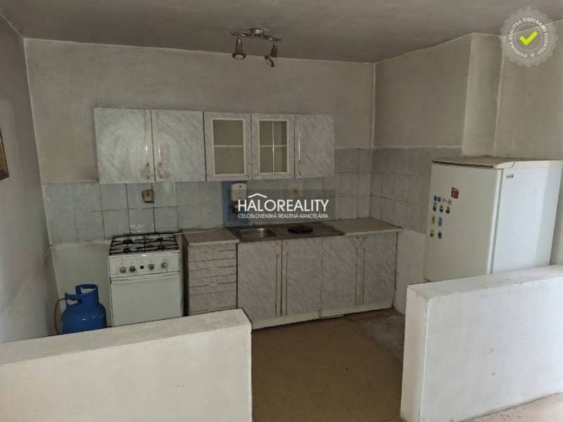 Kitchen unit with a gas stove and refrigerator in the interior. Land - housing.