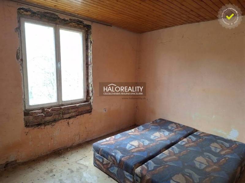Room with a bed, unfinished walls, and a wooden ceiling, category Land - housing.