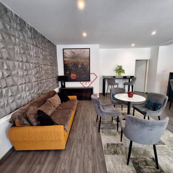Living room in a family house with a comfortable sofa and dining chairs.