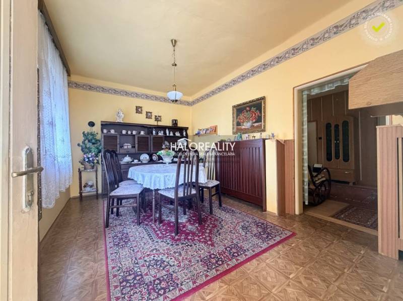 A gently tuned dining room in a family house with a wooden decor floor.