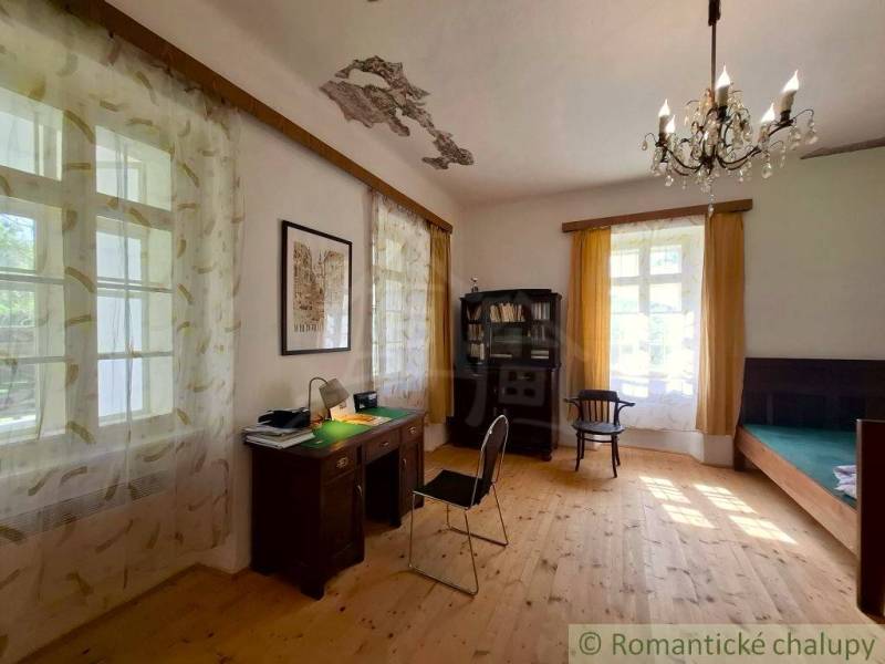 Interior of a family house with a desk, shelf, and floor with a wooden decor.
