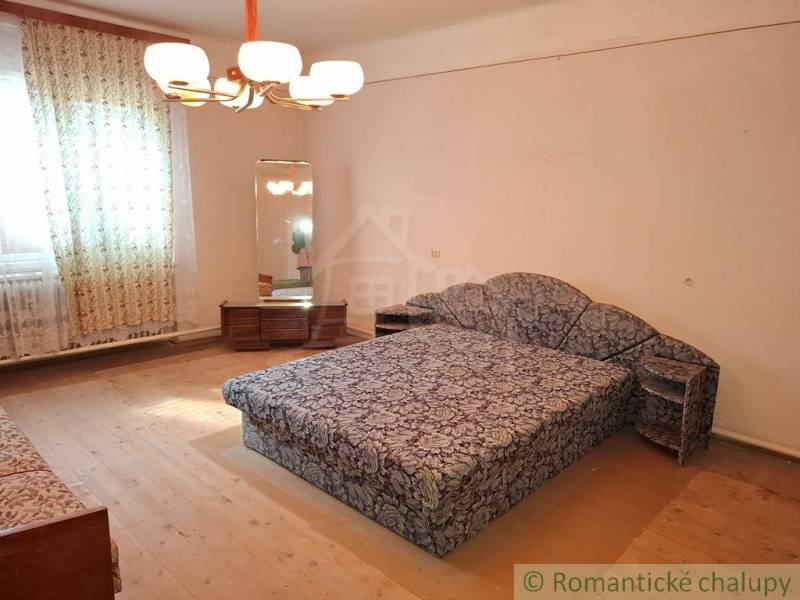 A room in a family house with carpet furniture and a mirror, wooden decor flooring.