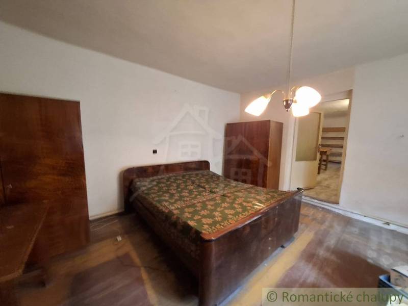 A bedroom in a family house with wooden cabinets and a wooden decor floor.