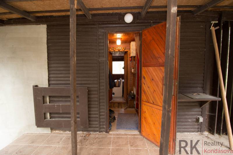 Entrance to the cabin with opening wooden doors and a porch on Recreational Land.