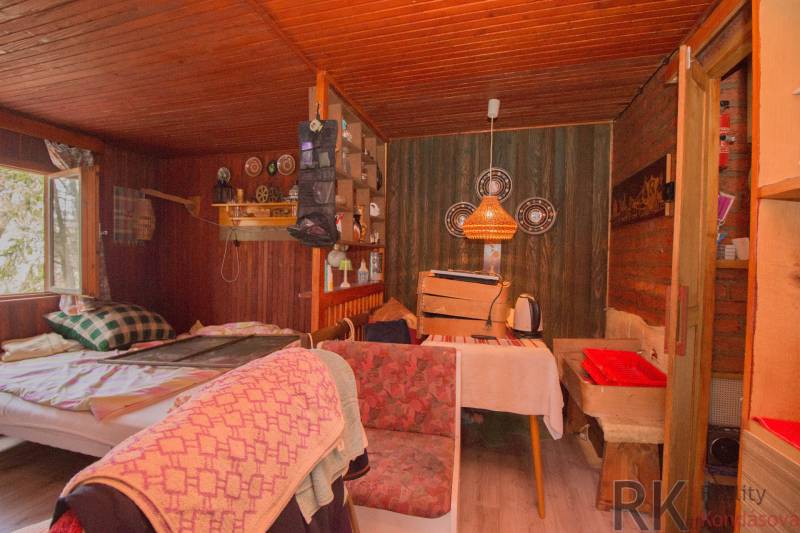 A rustic room on recreational grounds with wooden decor and comfortable seating.