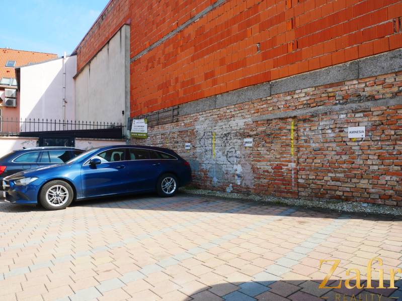 Parking lot near the brick building in the gastro premises of Trnava.