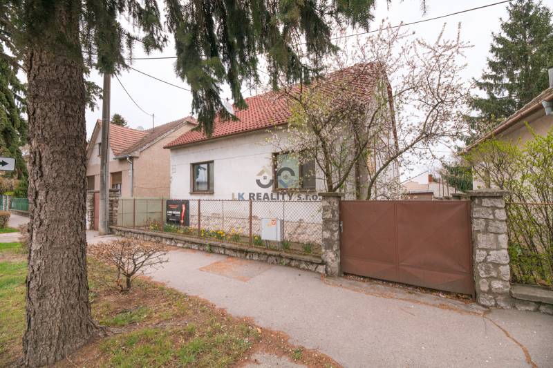 A family house on Zelenečská Street in Trnava with a front garden and a gate.