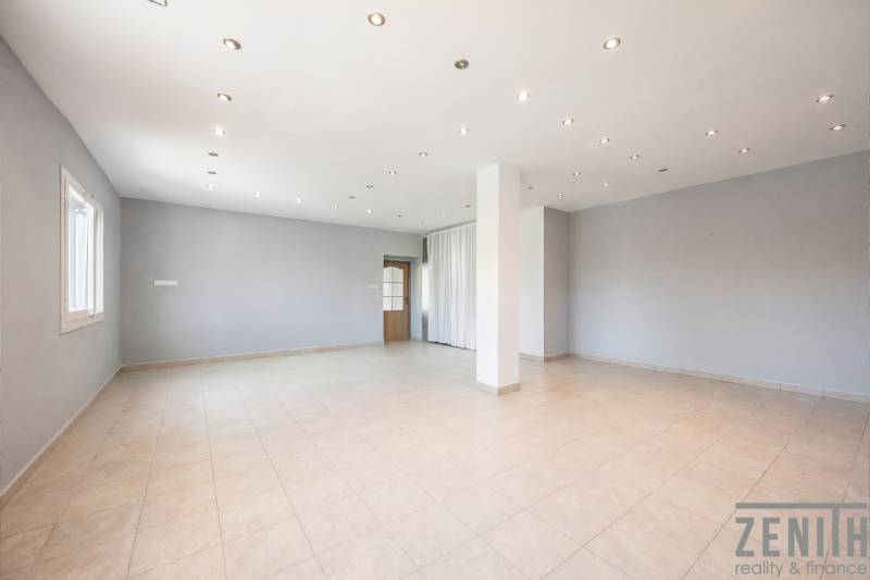 Commercial premises with white walls, ceramic flooring, and spot lighting.