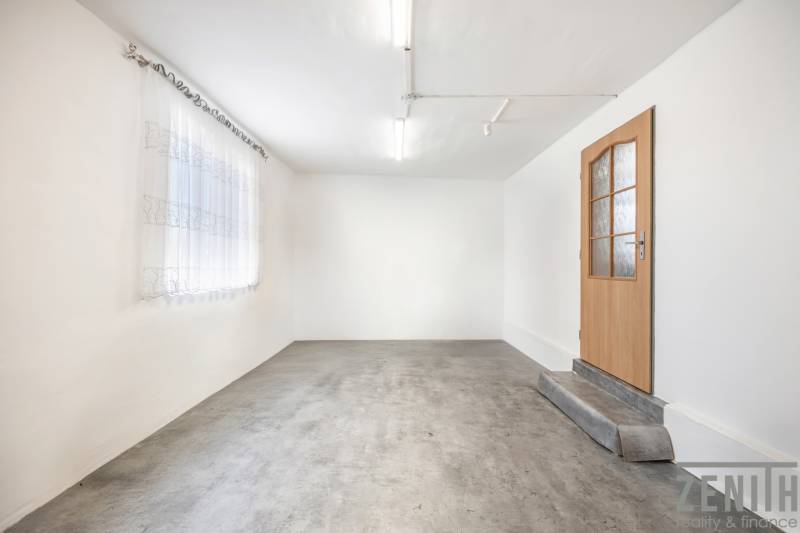 White walls, concrete floor, wooden door, and curtain in commercial premises.