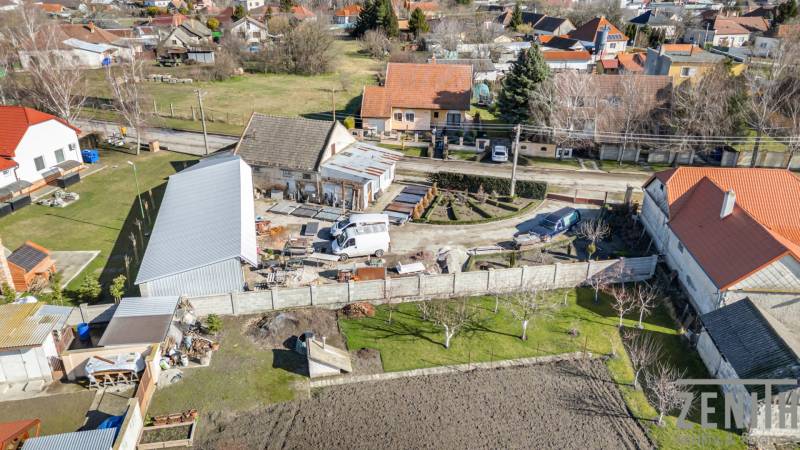 Commercial premises in Okoč with surrounding houses in a peaceful rural area.