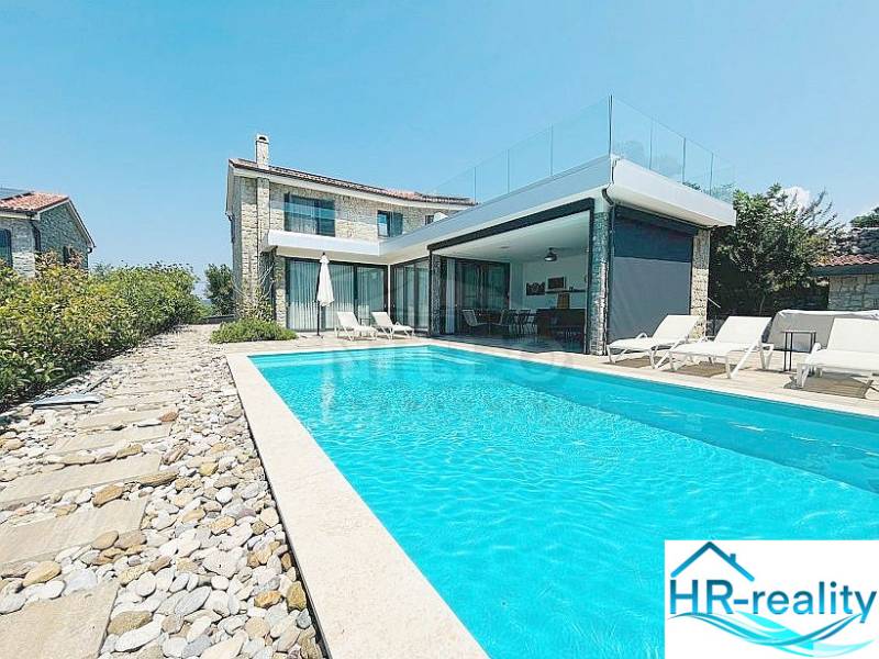 Villa in Jakišnica with a pool and stone terrace, surrounded by greenery.