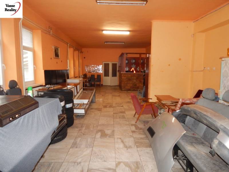 Interior of gastro spaces with orange walls, storage area with chairs and equipment.
