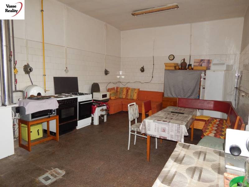 Interior of gastronomic spaces with equipped kitchen and sofa, floor with wooden decor.
