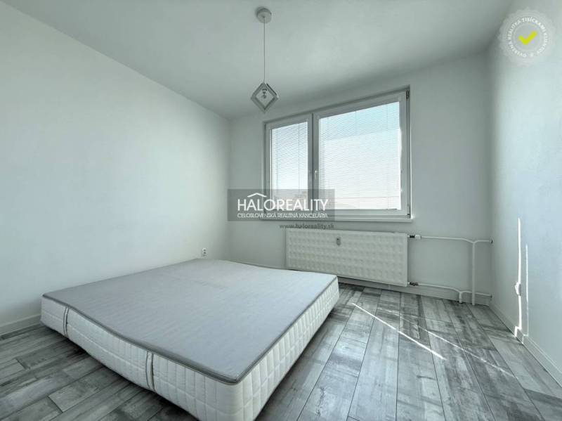 Bedroom with a gray floor featuring a wood design in a 2-room apartment.
