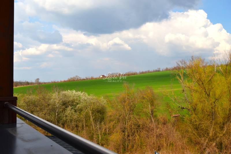 View from a 2-room apartment to the green fields in Podhájska in Svätuša.