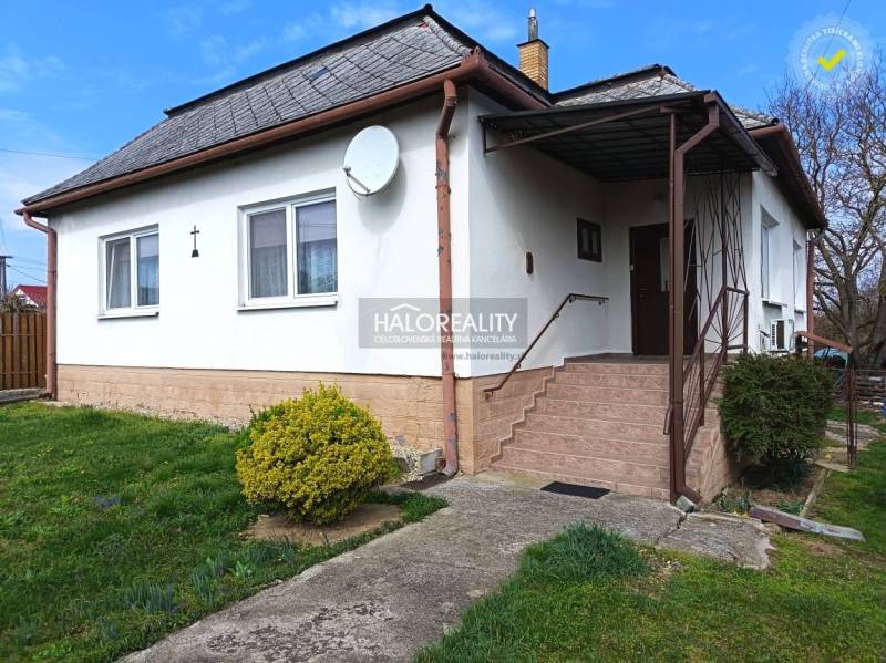 A family house in Hráň with a white facade, staircase, and garden.