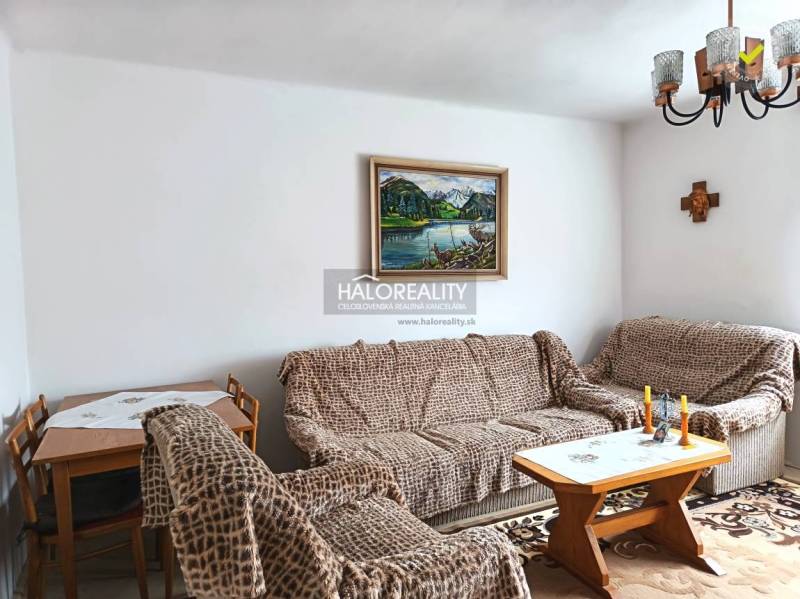 Living room in a family house with sofas and a painting on the wall.