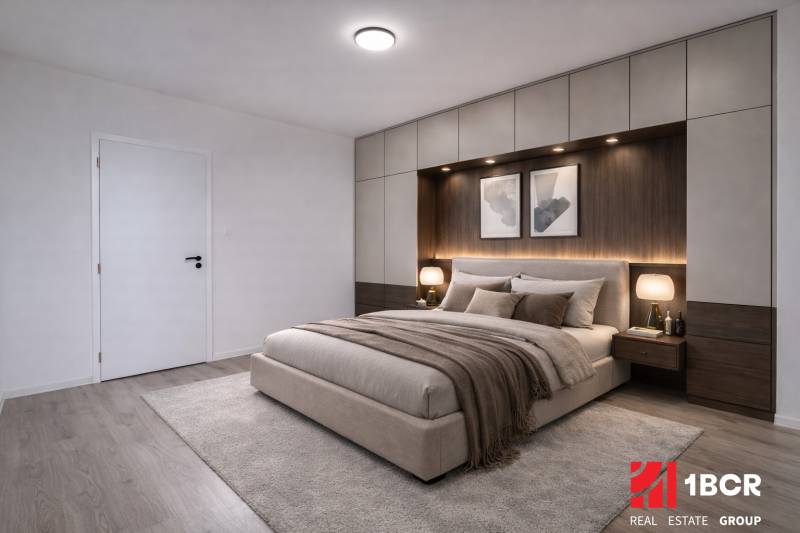 A bedroom in a 3-room apartment with carpet, wood-patterned flooring, and built-in cabinets.