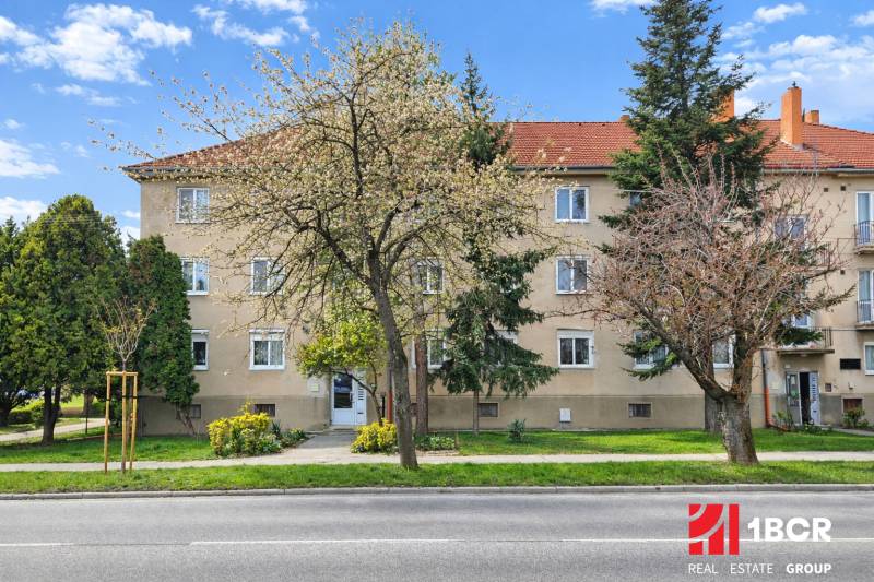 An apartment building on Dukelská Street in Bernolákovo with three floors and surrounding greenery.